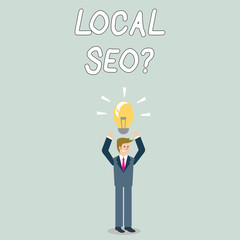 Word writing text Local Seoquestion. Business photo showcasing incredibly effective way to market your local business online Businessman Standing Raising Arms Upward with Lighted Bulb Icon on his Head