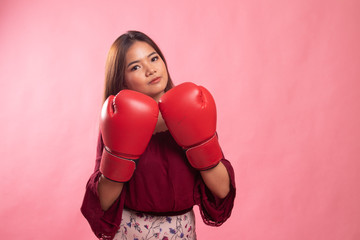 Young Asian woman with red boxing gloves.