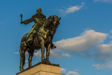 Fototapeta na wymiar Prague, Czech Republic - May 21 2019: Equestrian Statue of Jan Zizka of Trocnov made of bronze standing at pedestal. It is placed at Vitkov hill. Sunny spring day, blue sky with white clouds.