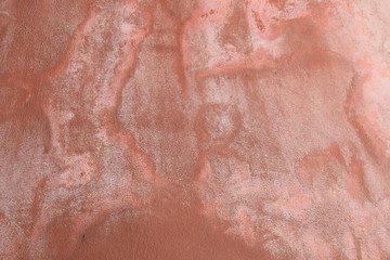 Wall plastered with mortar finished by hand in brown color