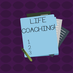 Word writing text Life Coaching. Business photo showcasing demonstrating employed to help showing attain their goals in career Colorful Lined Paper Stationery Partly into View from Pastel Blank Folder