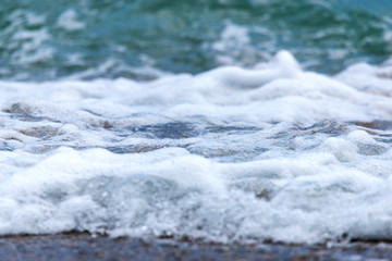 Seashore on stone beach. Close up view.