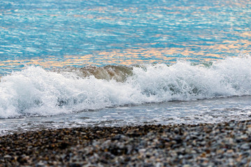 Seashore on stone beach. Close up view.
