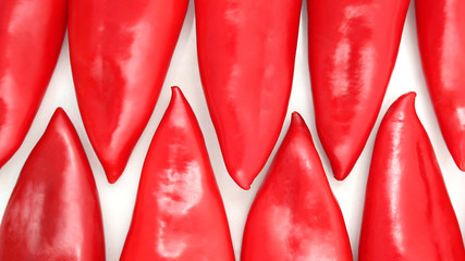 group of red sweet peppers on a white background