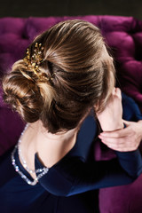 Fototapeta premium beautiful young woman in a blue sexy dress. luxury. beauty blond sitting girl. fashion portrait. evening hairstyle with decoration