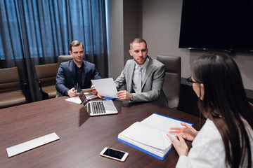 Coworkers meeting at conference room to discuss project in office