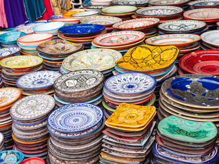 Traditional Moroccan marrakech market with plates and tajin tagine. Handmade ceramic plates....