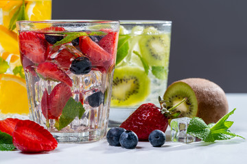 detox smoothies of fresh fruits and vegetables on dark background