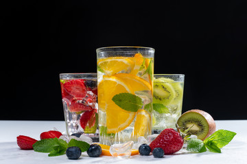 detox smoothies of fresh fruits and vegetables on dark background