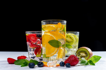 detox smoothies of fresh fruits and vegetables on dark background