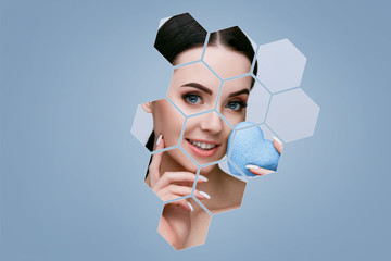 Portrait of model in hexagon frames. Beautiful young woman with perfect glow skin. Blue heart...