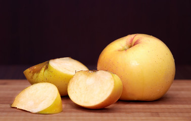 Naklejka na ściany i meble Whole and cut-up apples on cutting board