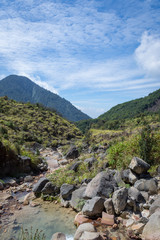 Fototapeta na wymiar Rocky stream with clear water on a mountain. Beautiful landscape of mount Papandayan. Papandayan Mountain is one of the favorite place to hike on Garut.