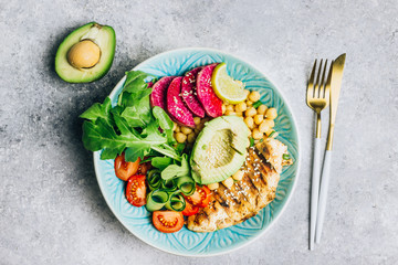 Grilled chicken and fresh vegetable salad. Healthy diet food concept. On a light background, top view