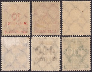 The reverse side of old postage stamps with the remnants of glue.Translucent numbers and letters