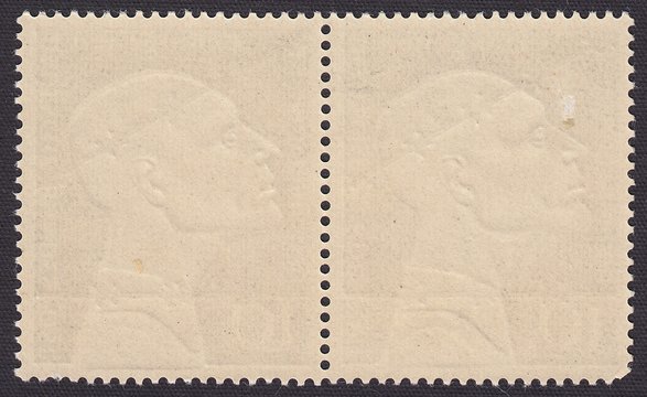 The reverse side of a postage stamp with embossed profile head of a man