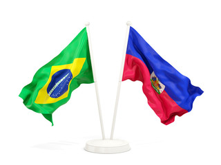 Two waving flags of Brazil and haiti isolated on white