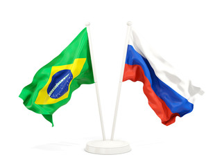 Two waving flags of Brazil and russia isolated on white