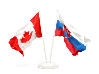 Two waving flags of Canada and slovakia isolated on white