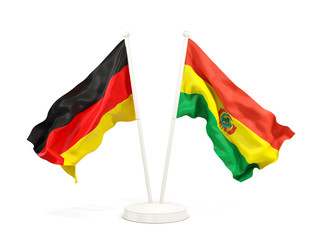 Two waving flags of Germany and bolivia isolated on white