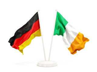 Two waving flags of Germany and ireland isolated on white