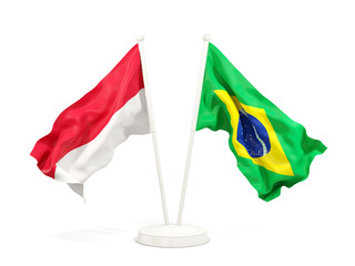 Two waving flags of Indonesia and brazil isolated on white