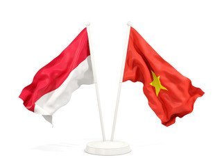 Two waving flags of Indonesia and vietnam isolated on white