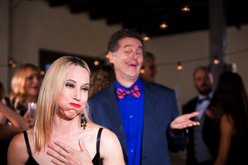 Woman at Party Disgusted with Boorish Man