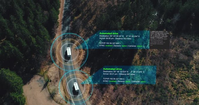 Helicopter shot of self Driving trucks driving on a forest highway with technology assistant tracking information, showing details. Visual effects clip
