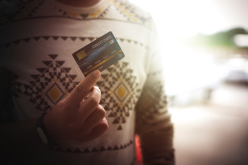 Hands holding plastic credit card for pay. This is Shopping concept