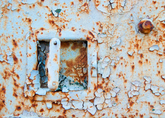 The lock on the old iron trailer - Old age, vintage, metal corrosion, layers of old peeling paint of different colors