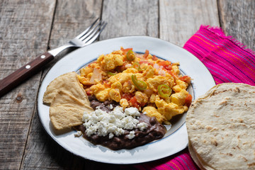 Mexican style scrambled eggs with fried beans, cheese and jalapeno