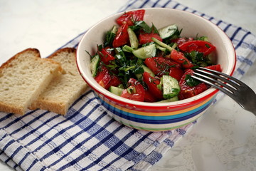 Cup with vegetable salad on light background