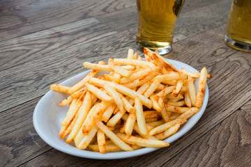 fried potatoes and beer on pub table