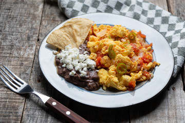 Mexican style scrambled eggs with fried beans, cheese and jalapeno