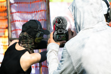 young men takes video with camera at shooting range under the daylight