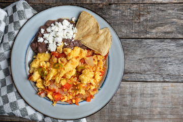 Mexican style scrambled eggs with fried beans, cheese and jalapeno