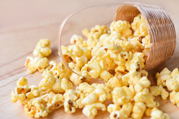 Popcorn in basket and wooden backgroubd - Sweet butter popcorn salt