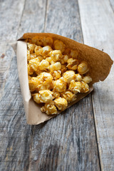 Sweet popcorn with caramel in paper bag