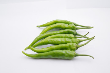 Group of fresh green chili peppers isolated on white background