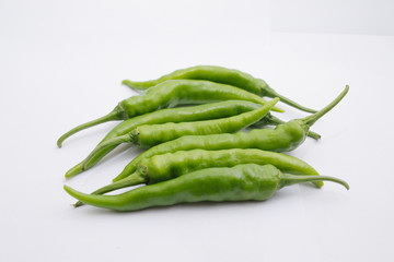 Group of fresh green chili peppers isolated on white background