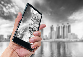 Hand holding smartphone landscape nature background