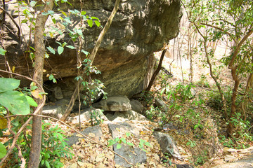 Mouth of a spring, natural fountain, subterranean course of water from big stone in the forest at Op Luang National Park, Hot, Chiang Mai, Thailand.
