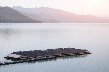 Row of solar cells floating on the water in solar power station.  Rows array of polycrystalline...