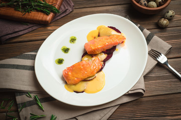 Healthy baked fish with olive oil and sauce. Menu for a cafe with homemade style cuisine.