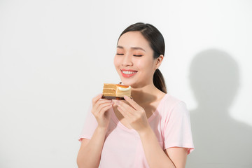 Beautiful smiling asian young woman with a chocolate cake isolated on white background.