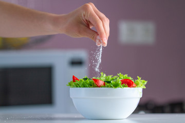 Vegetable, fresh salad bowl seasoned with salt for a healthy snack