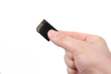 Hand with SD card isolated on white background.