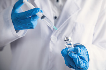 Doctor filling a syringe. The concept of vaccination