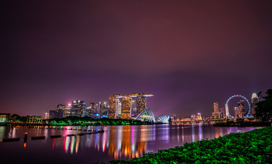 Fototapeta na wymiar SINGAPORE-MAY 18, 2019 : Cityscape Singapore modern and financial city in Asia. Marina bay landmark of Singapore. Night landscape of business building and hotel. Panorama view of Marina bay at dusk.